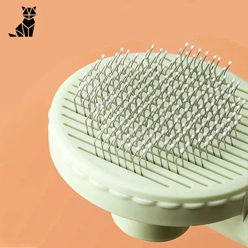 Peigne à chat - Design ergonomique pour Poils Morts, brosse blanche avec manche blanc sur fond rose